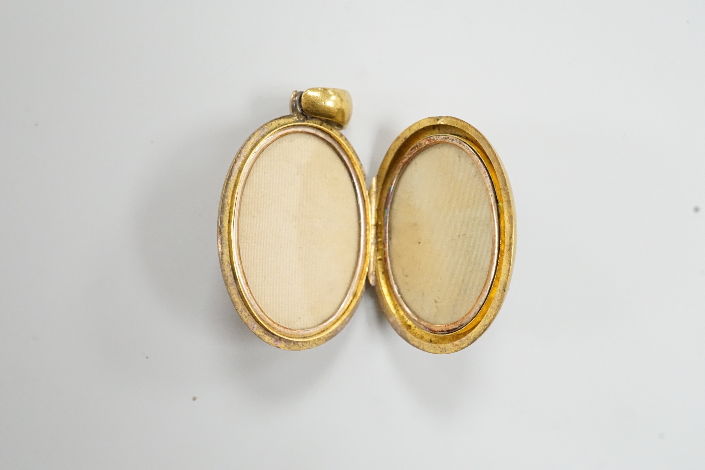 A Victorian yellow metal and enamelled oval locket, 39mm, gross weight 13.2 grams.